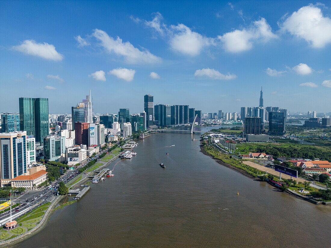  Aerial view of Saigon River with city skyline and Landmark 81 tower in the distance, Quan 4, Ho Chi Minh City, Vietnam, Asia 