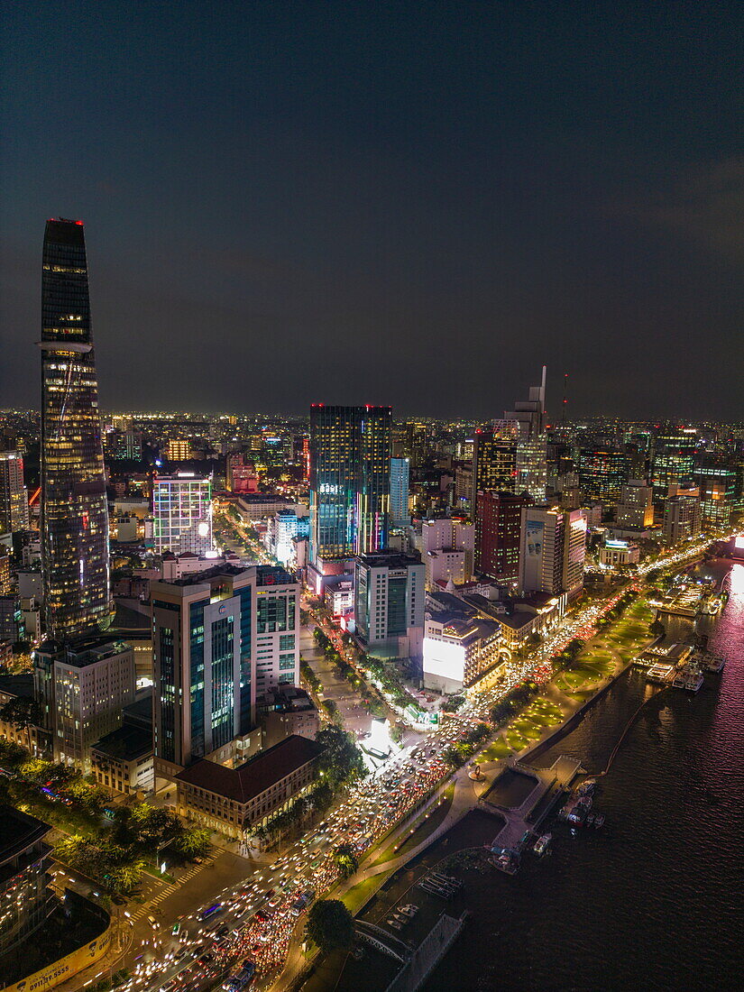  Aerial view of rush hour traffic along Saigon River with skyscrapers in downtown District 1 at night, Quan 4, Ho Chi Minh City, Vietnam, Asia 