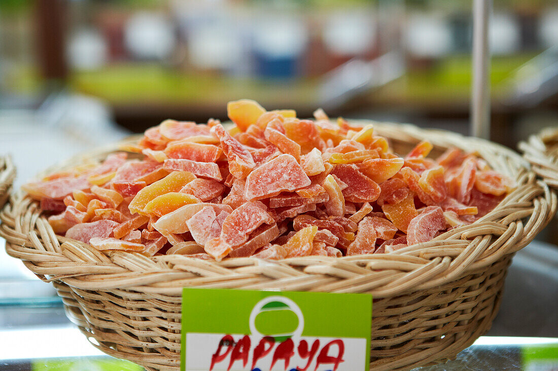 A basket full of dried papaya slices displayed for sale in a local supermarket. Bodrum, Mugla Province, Turkey.