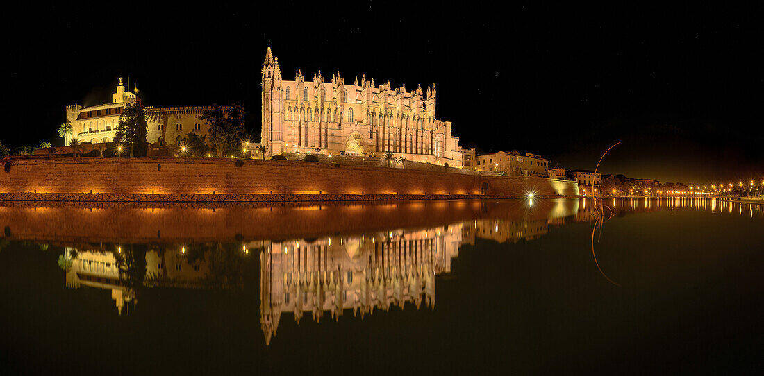  Cathedral of Saint Mary at night with water reflection in the Spanish port city of Palma, Mallorca, Spain, panorama\n 