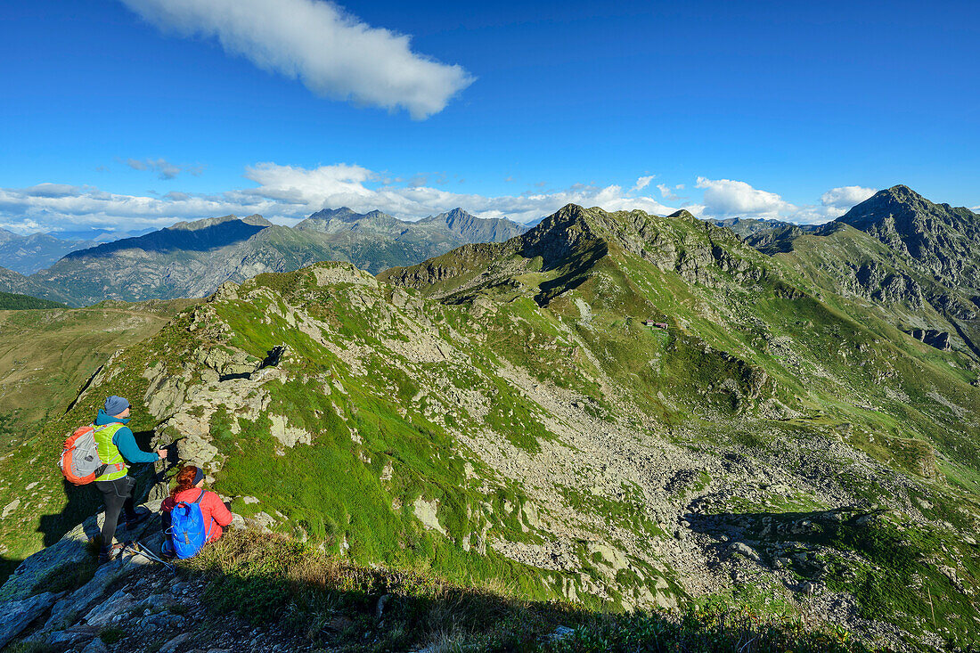  Man and woman hiking on the GTA looking at Monte Mars, Colma di Mombarone, GTA, Grande Traversée des Alpes, Biella, Alpi Biellesi, Valais Alps, Piedmont, Italy 