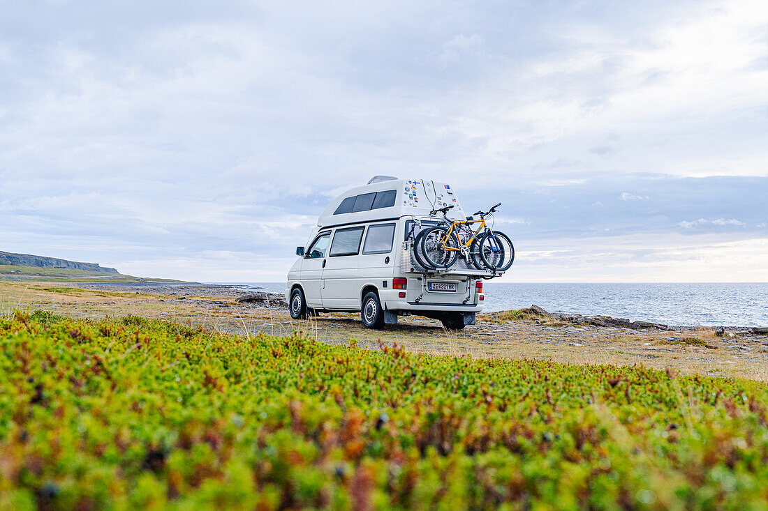 Norwegen, Finnmark, Varangerhalvøya, Wohnmobil an Küste mit Meerblick