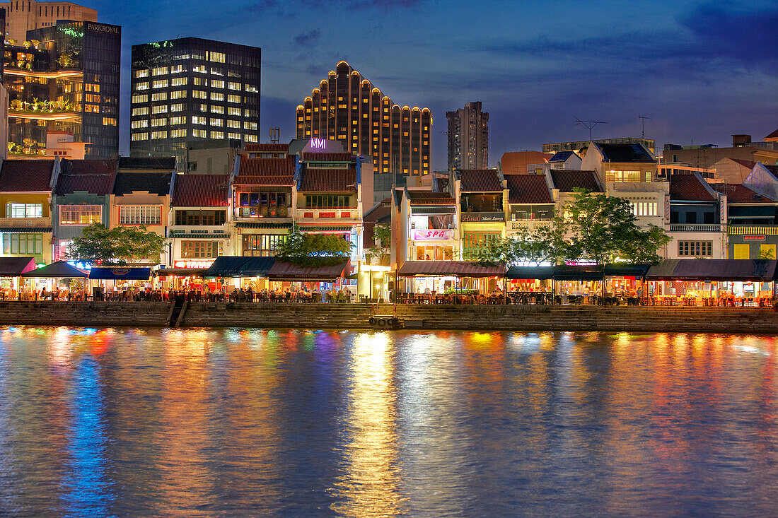 Exterior view of historic shophouses at Boat Quay illuminated at night. Singapore.