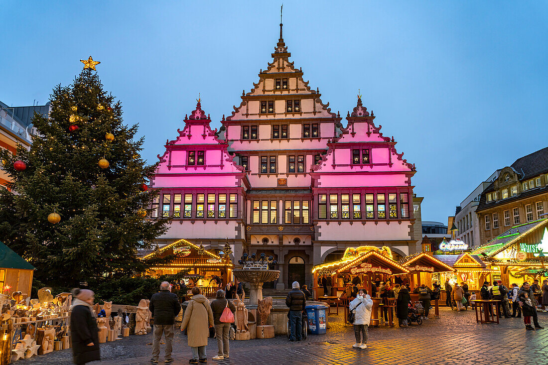  Christmas market at the colorfully illuminated Paderborn town hall at dusk in Paderborn, North Rhine-Westphalia, Germany, Europe 