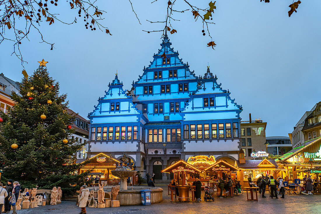  Christmas market at the colorfully illuminated Paderborn town hall at dusk in Paderborn, North Rhine-Westphalia, Germany, Europe 