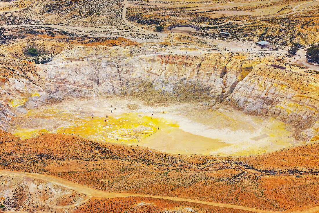 People walking around Stefanos crater moonlike landscape, Nisyros Island, Dodecanese Islands, Greece\n