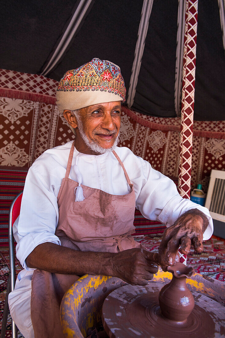 Salih potter, making a demonstration of his craft in the enclosure of the Fort of Nizwa, Ad Dakhiliyah Region, Sultanate of Oman, Arabian Peninsula, Middle East