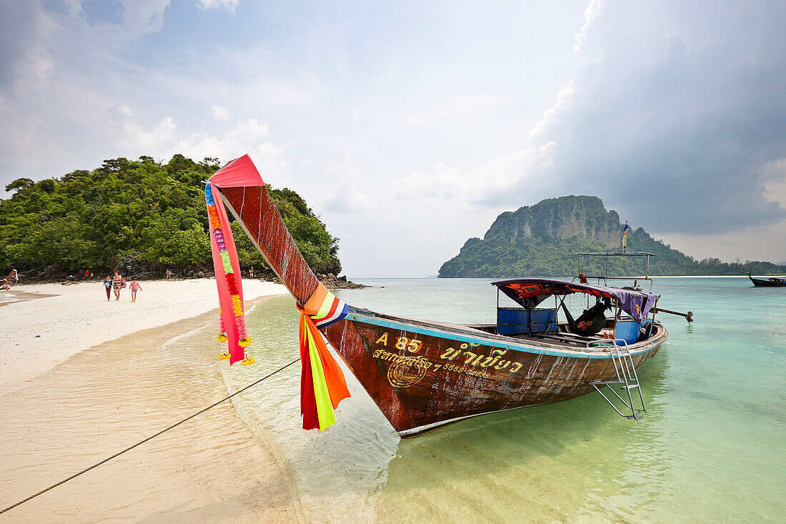 Traditional Thai long-tail boat moored at the beach on Tup Island, aka Tub Island, Koh Tap or Koh Thap. Krabi Province, Thailand.