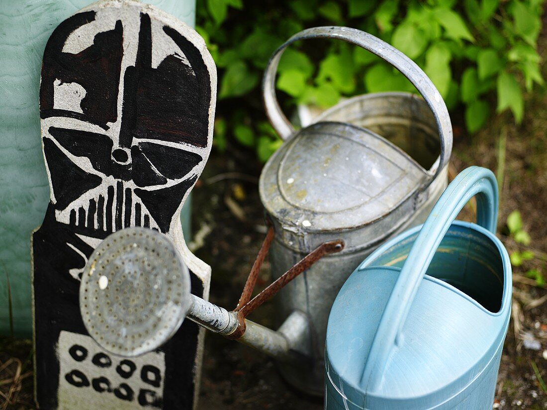 Watering cans in a garden