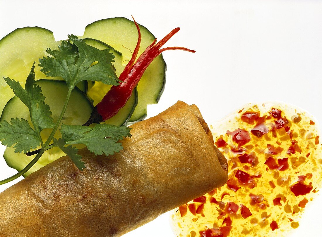 Close Up of Spring Roll with Sauce; Cucumber Slices