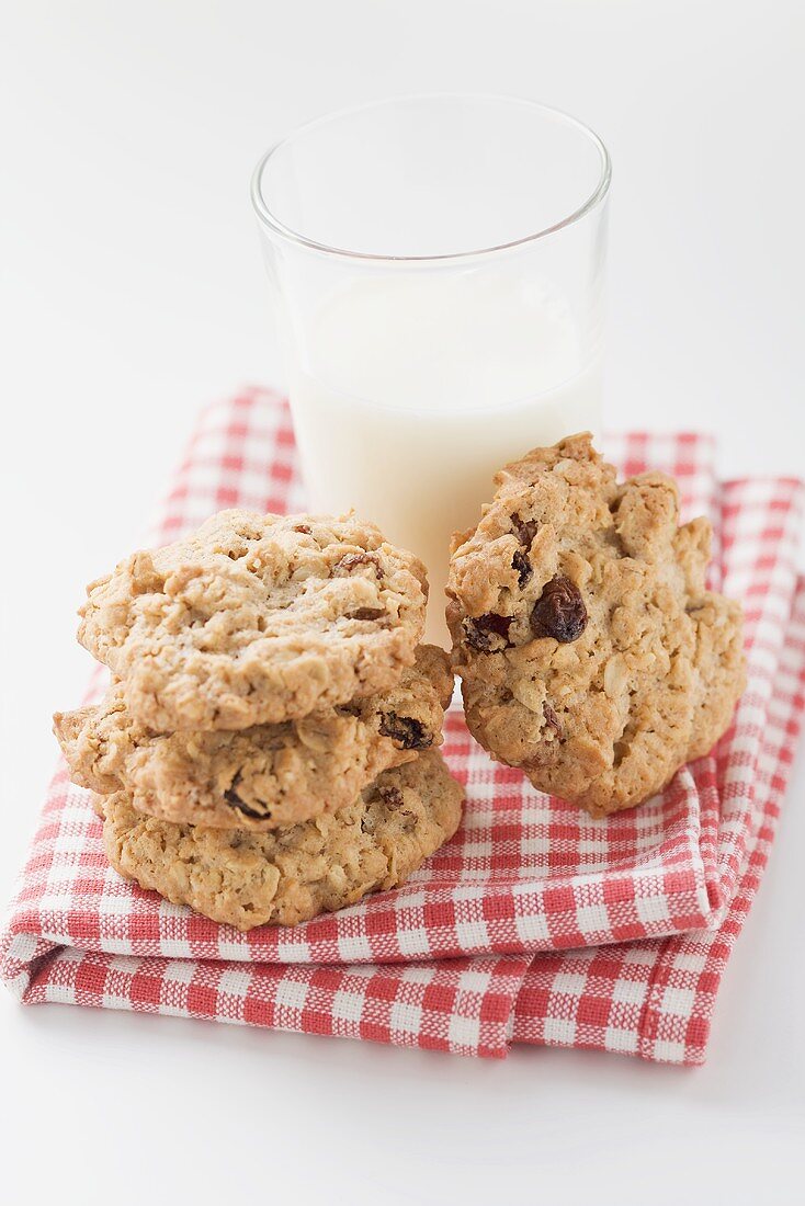 Cookies and glass of milk on checked cloth