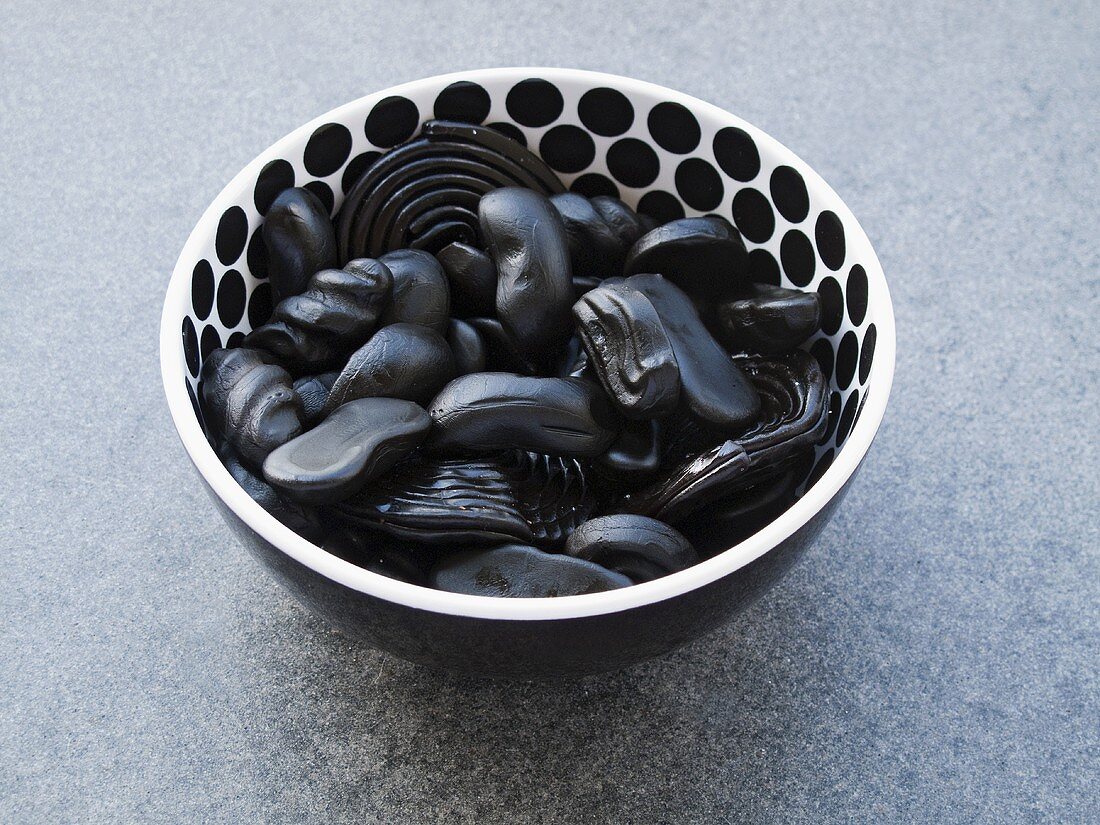 Liquorice sweets in spotted dish