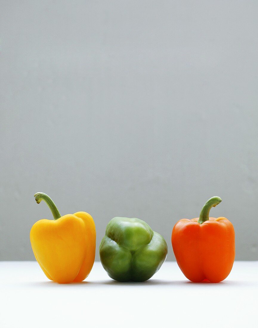 Three peppers (yellow, green, orange)