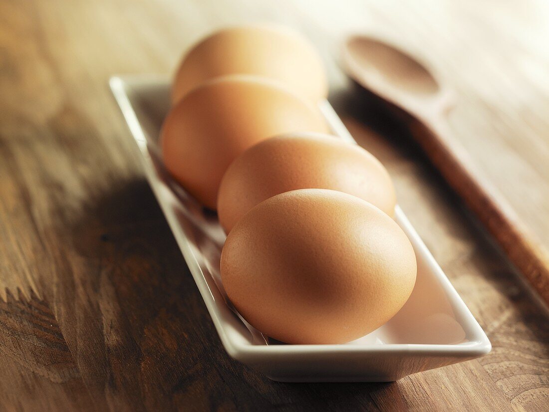 Brown eggs in a white dish