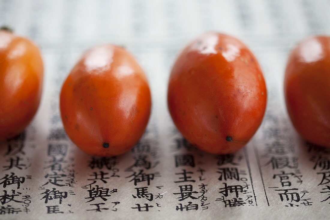 Japanese persimmons on paper with oriental writing