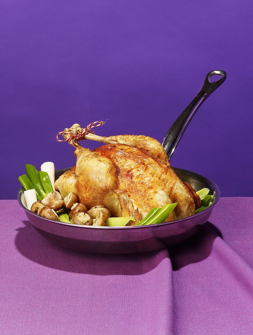Roast chicken with vegetables in a pan