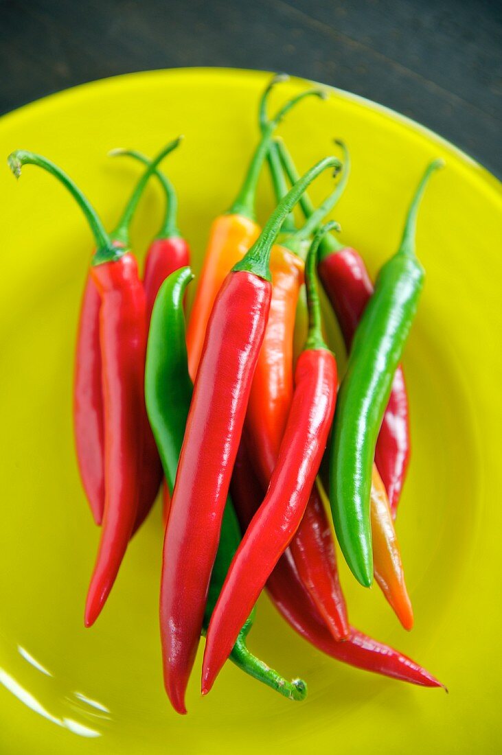 Red and green chilli peppers on a plate