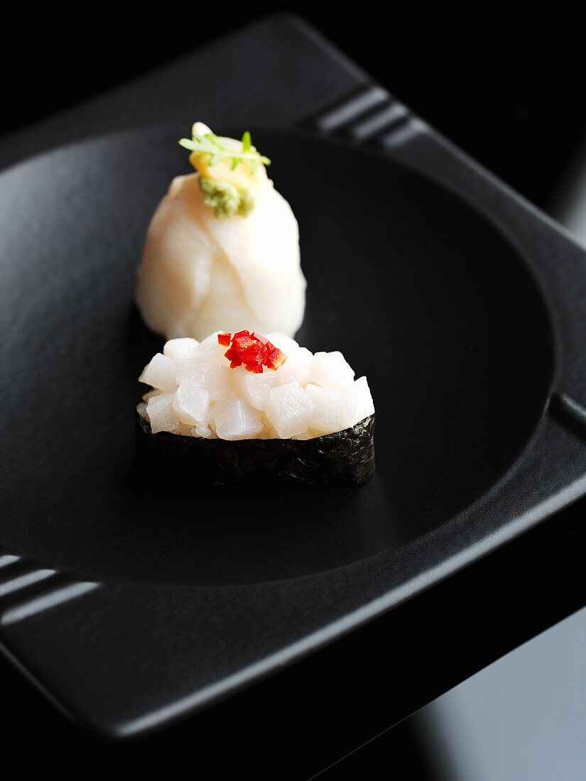 Sushi on a black dish