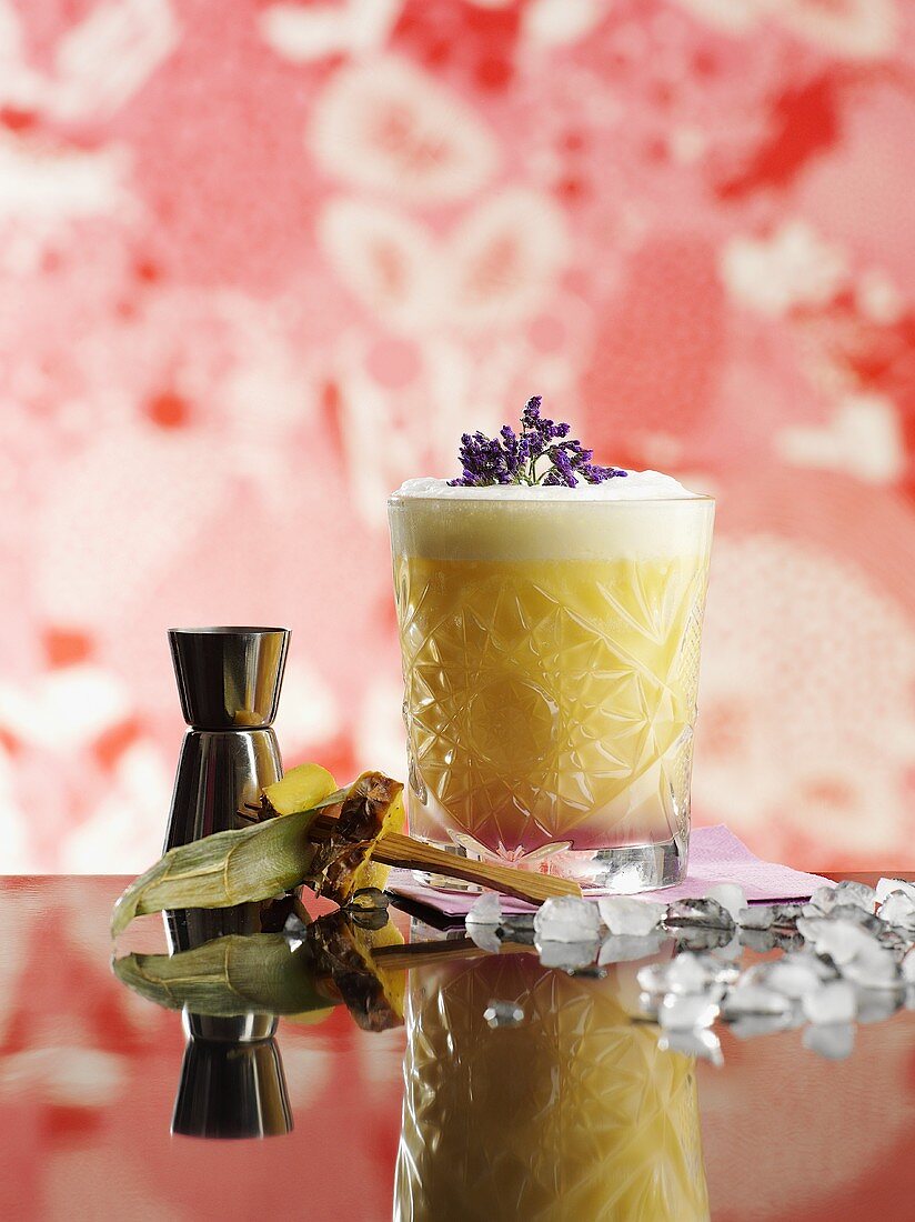 A pineapple drink with lavender flowers