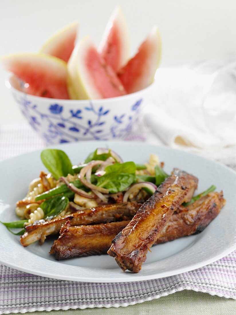 Pork ribs with pasta salad, watermelon wedges