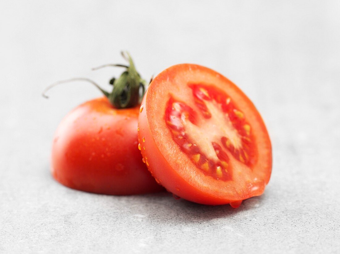 A freshly washed tomato, halved