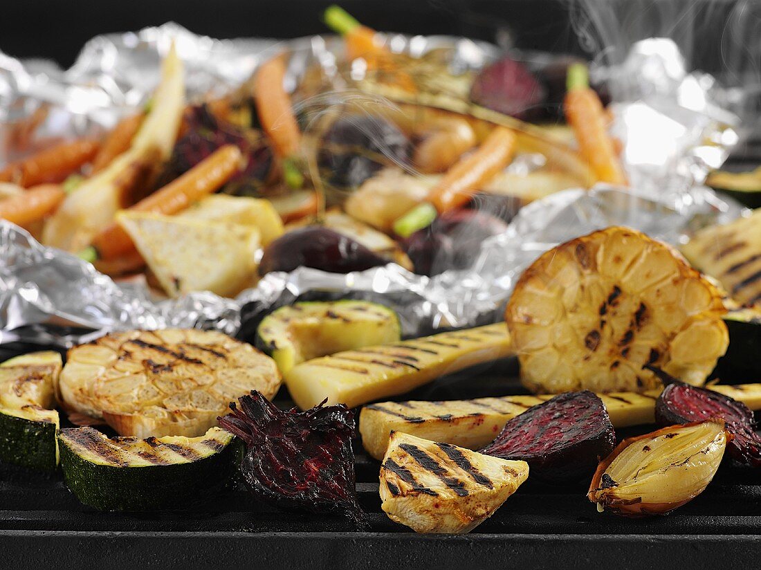 Root vegetables and garlic on a grill