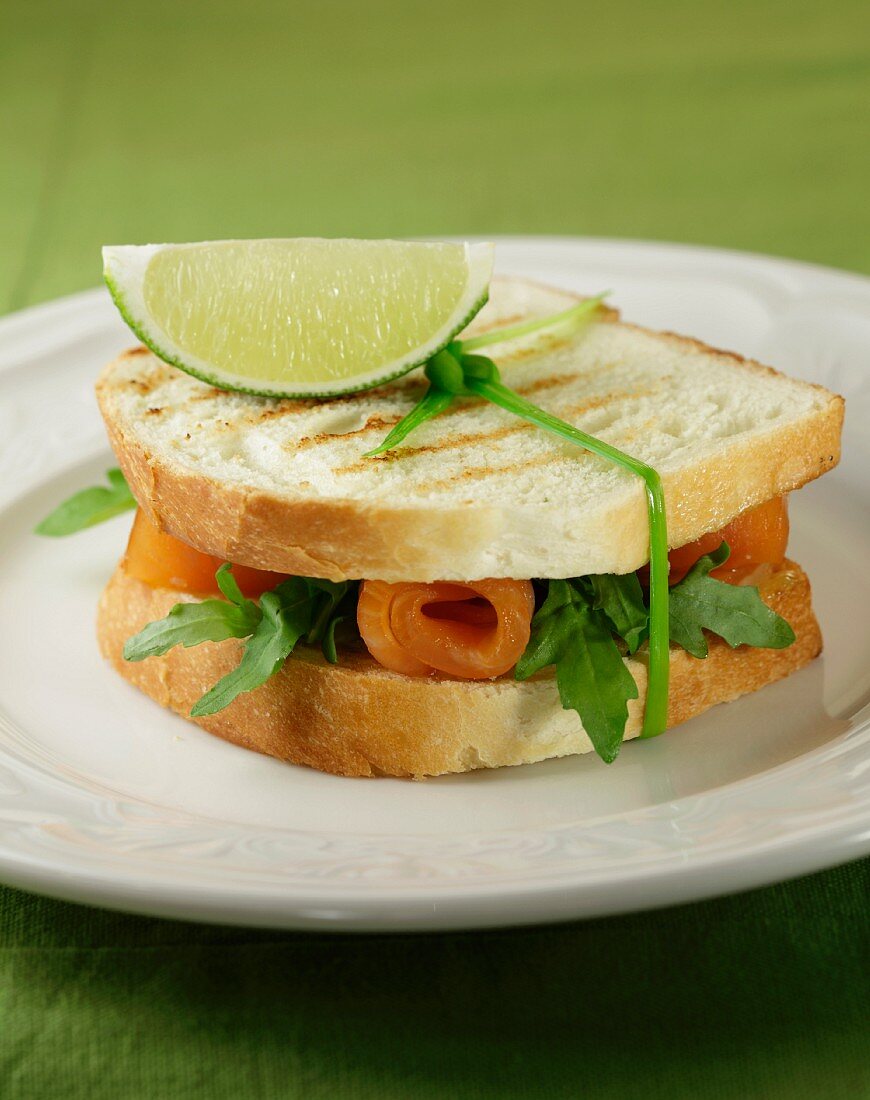 A toasted smoked salmon and rocket sandwich