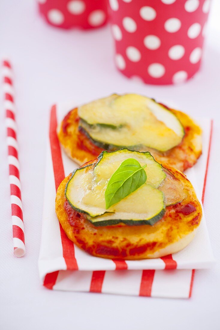 Mini-pizza with zucchini and basil