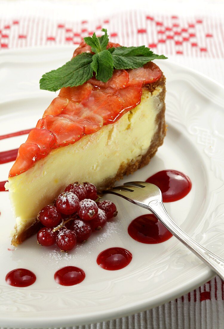 A piece of cheese cake with strawberry slices