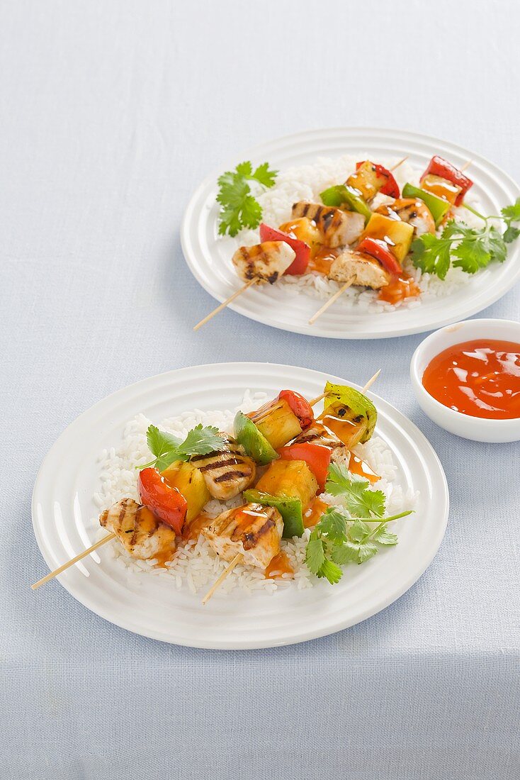 Sweet and sour chicken kebabs with rice