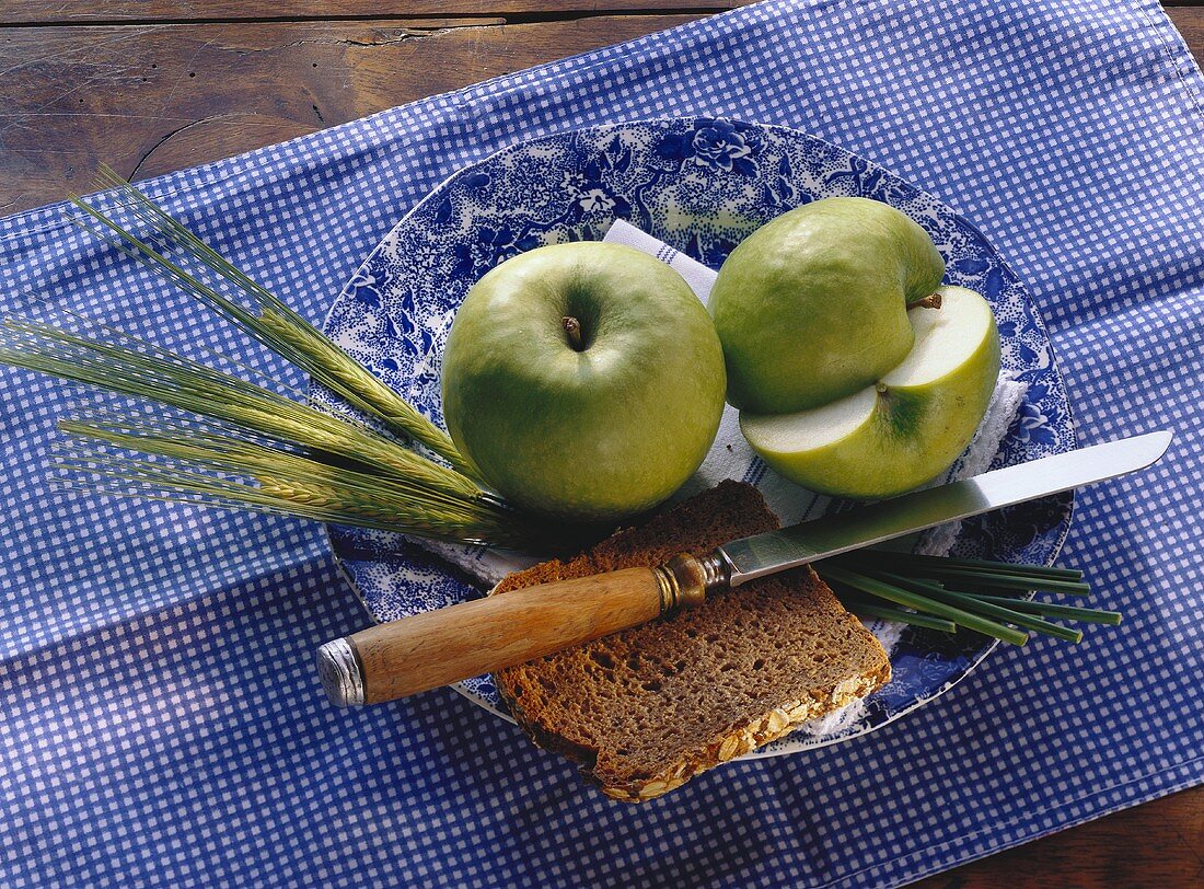 Two Granny Smiths; cereals; bread; plate
