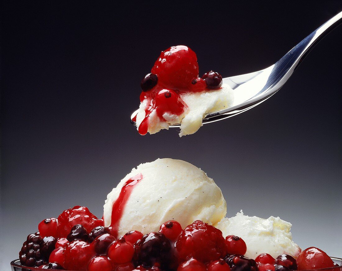 Vanilla Ice Cream with Red Berry Sauce; on Spoon