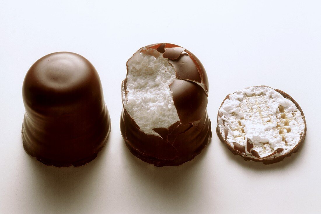 Chocolate marshmallows; one with a bite taken out