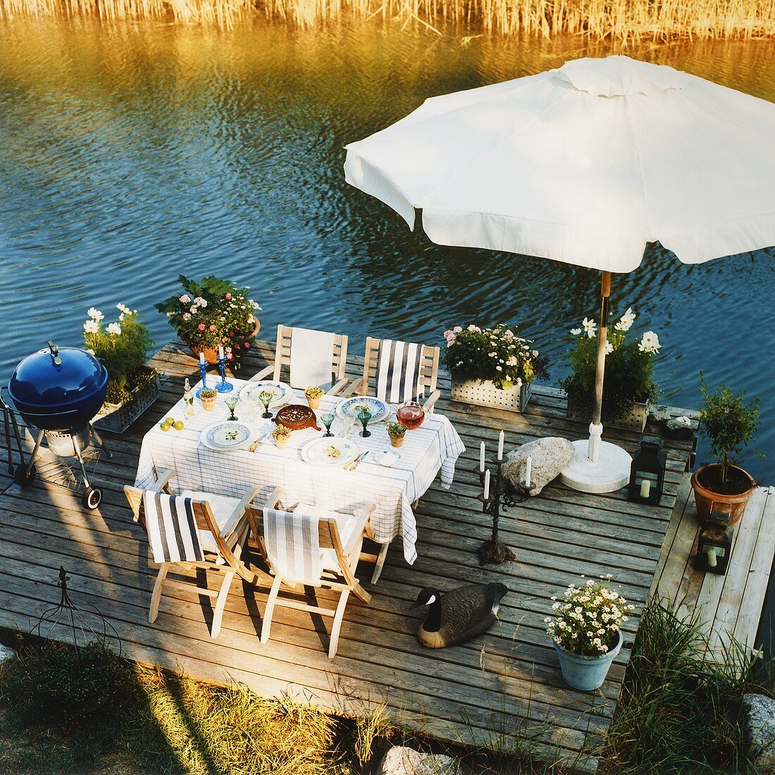 A table laid on a wooden jetty