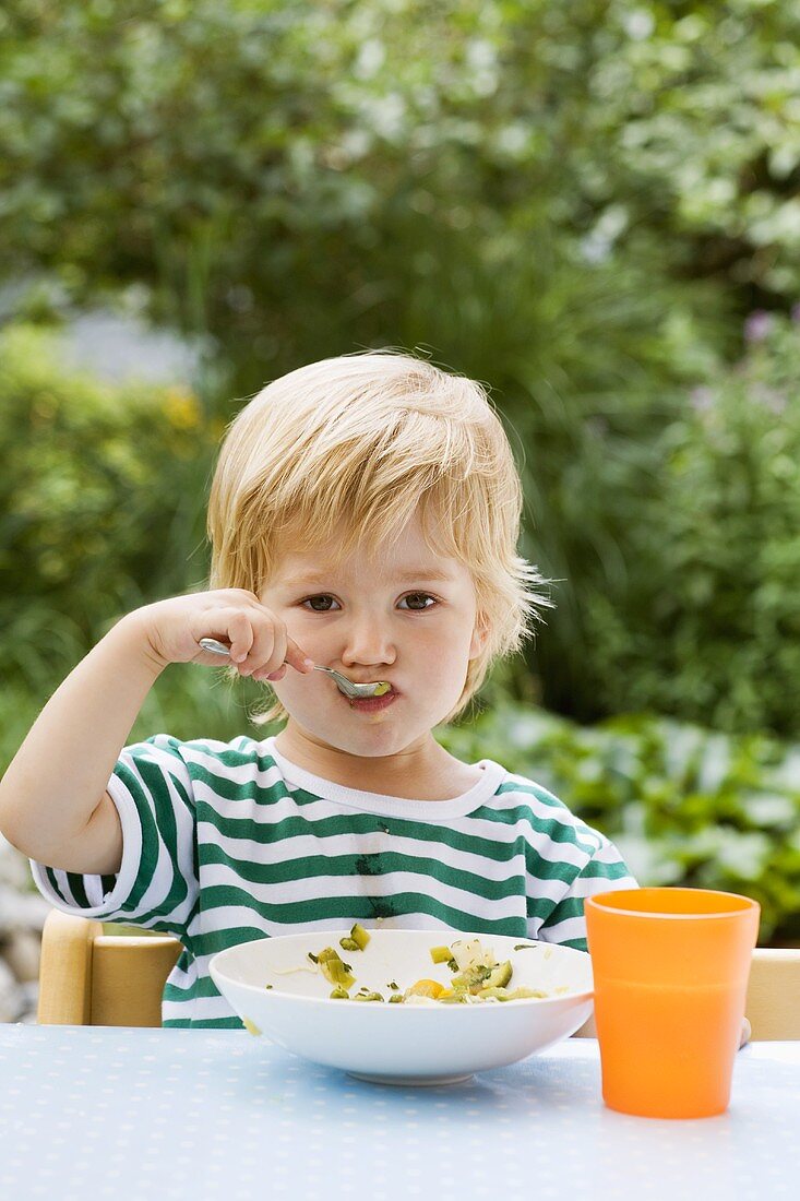 Boy with spoon in his mouth