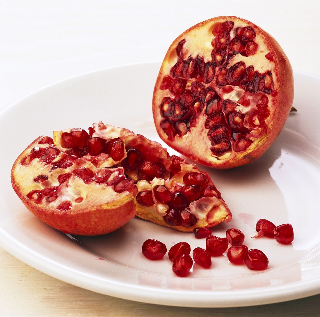 Pomegranate, halved, on plate