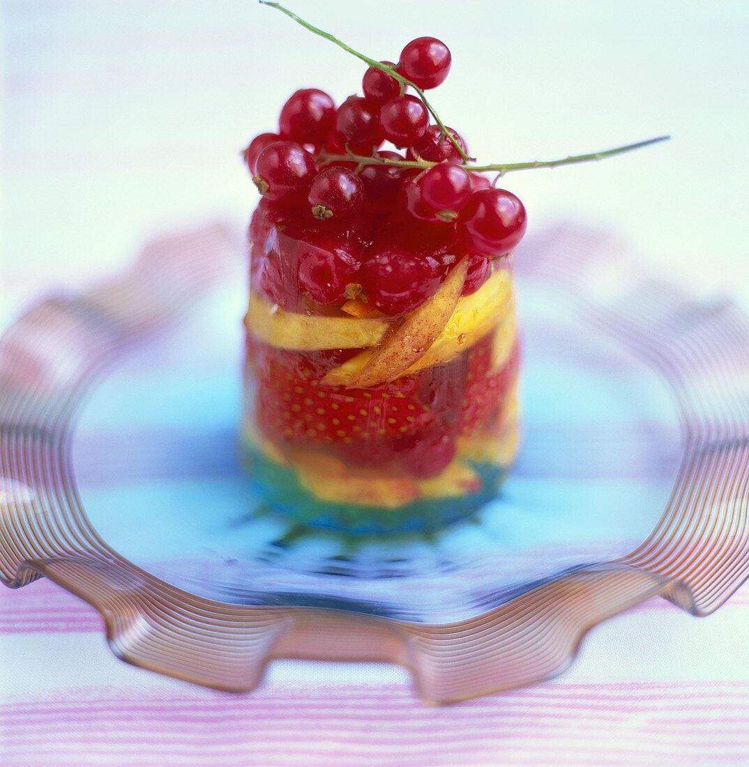 Jelly with berries and fruit on glass plate