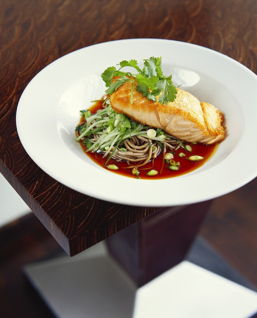 Salmon fillet on Asian noodles in soy sauce