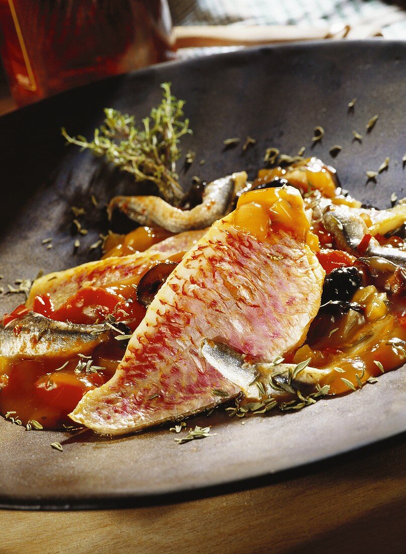 Fried red mullet with olives and tomato sauce