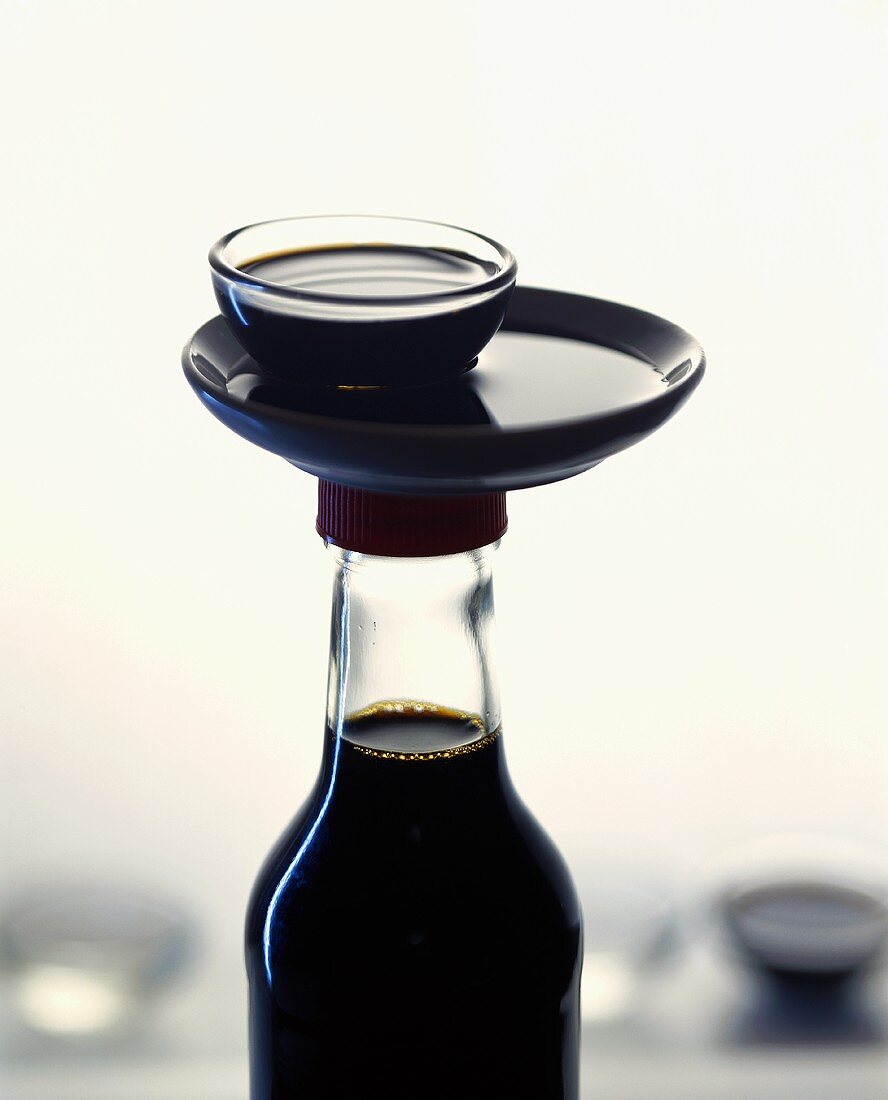 Soy sauce in bottle and small bowl