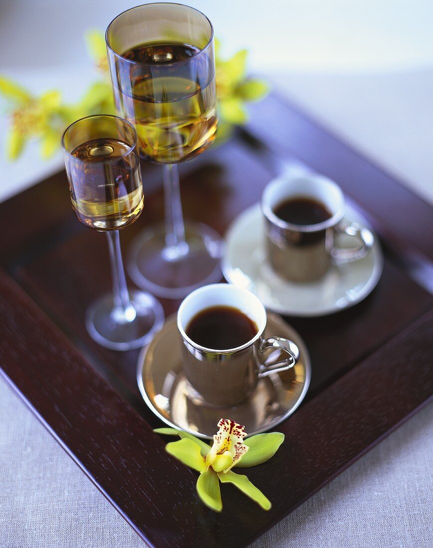Two cups of black coffee and liqueur on tray