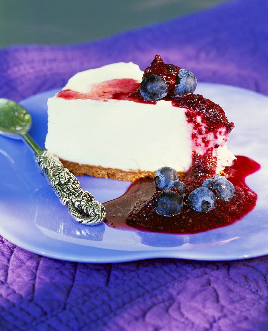 Piece of yoghurt cake with blueberry sauce