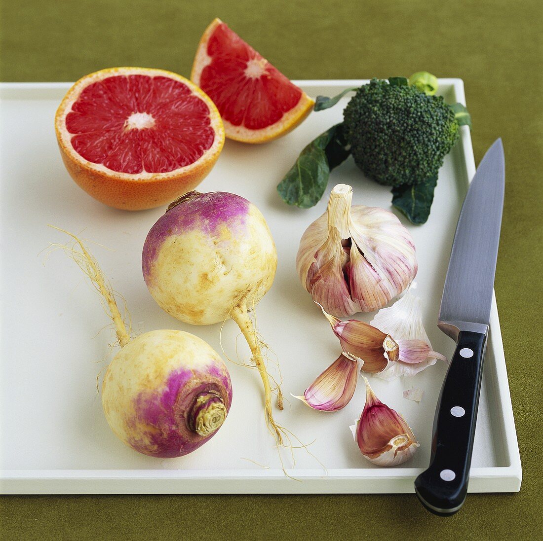 Blood orange, turnip, garlic and broccoli on chopping board