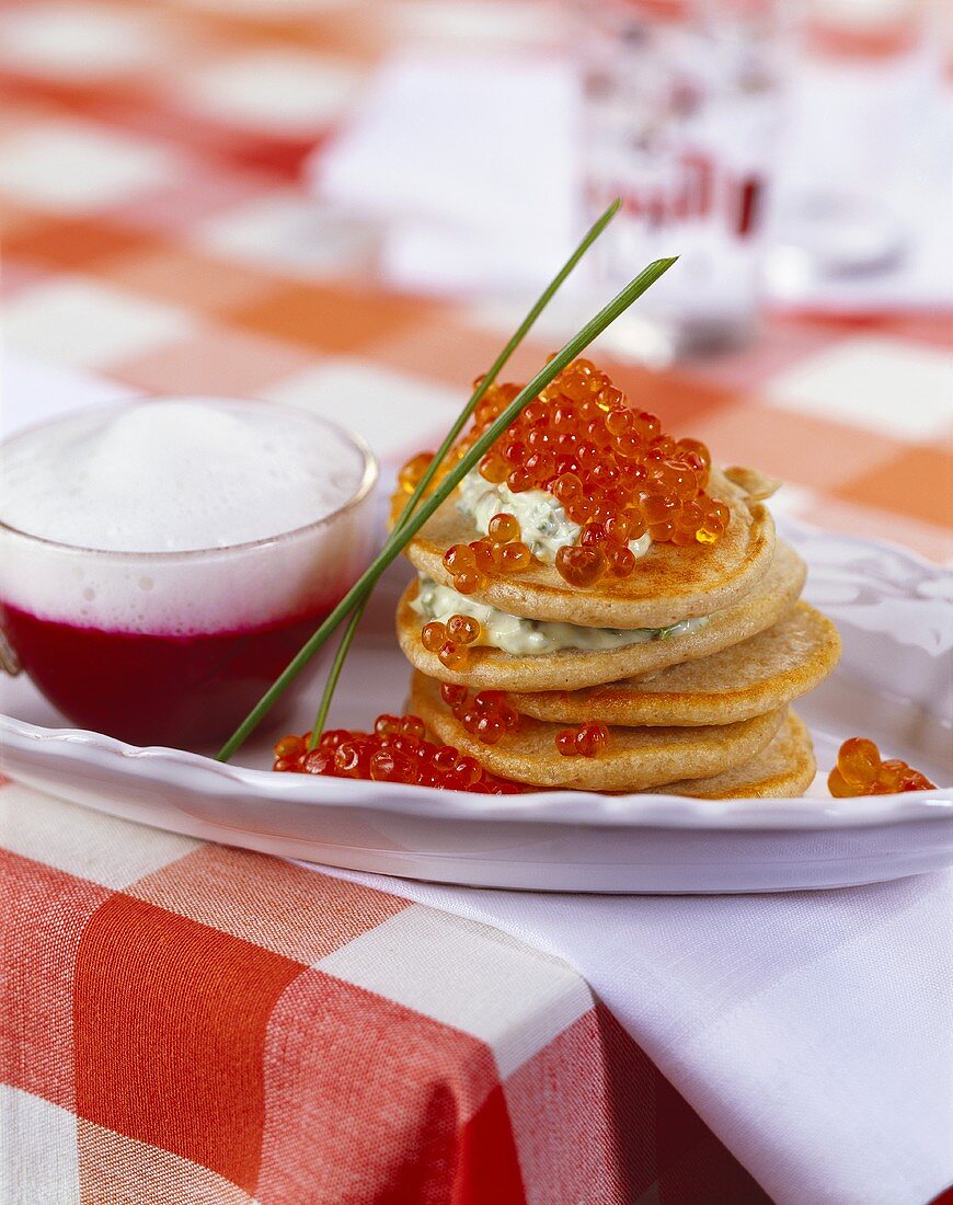 Blinis with caviar and beetroot sauce