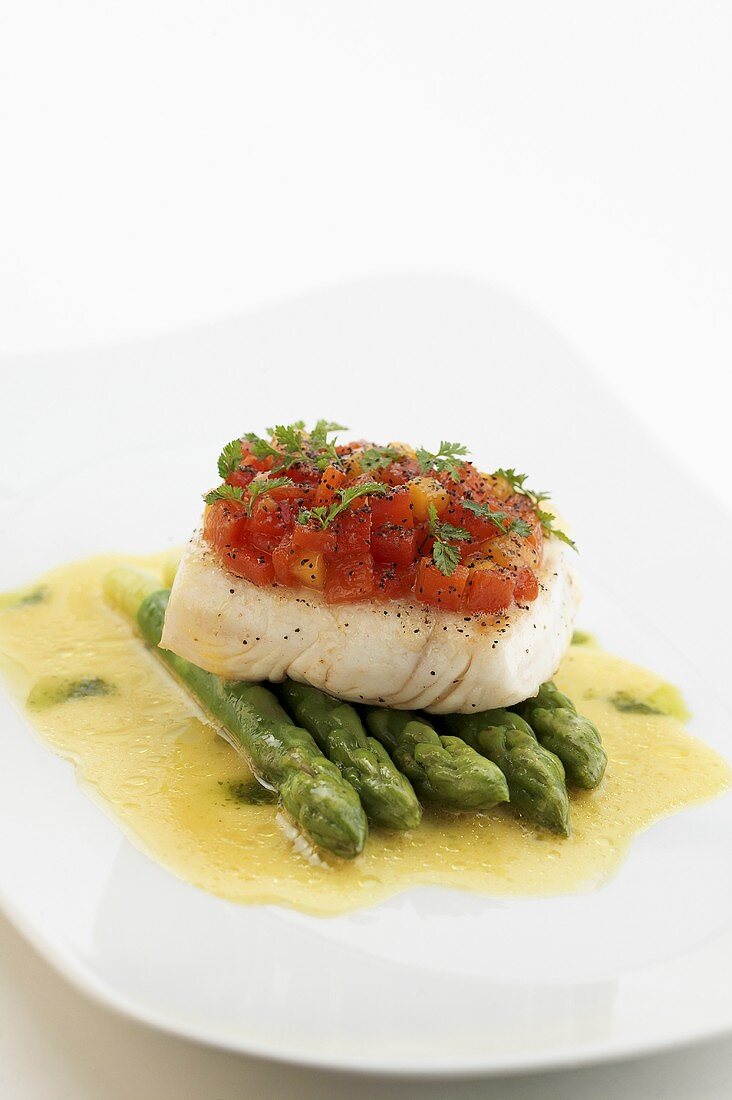 Halibut with tomato topping on asparagus & lemon sauce
