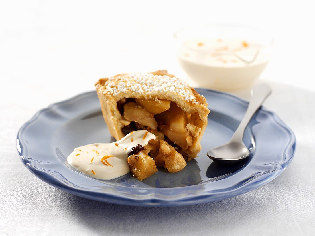 Small apple pie with cream and icing sugar