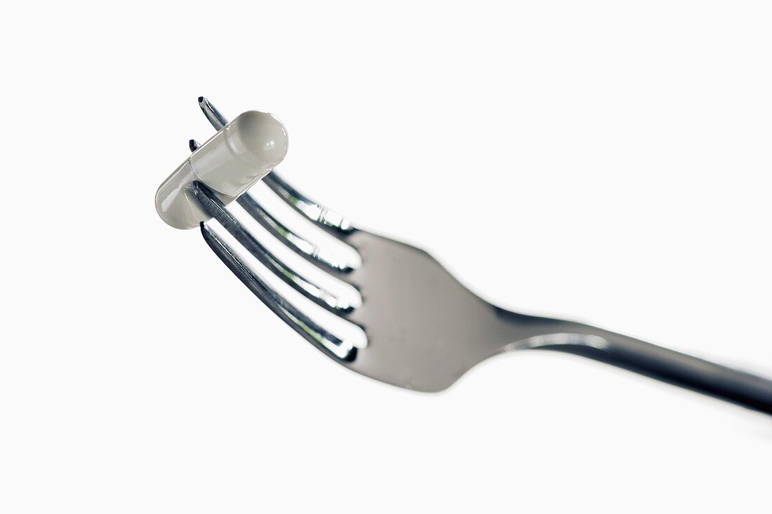 White capsule on fork