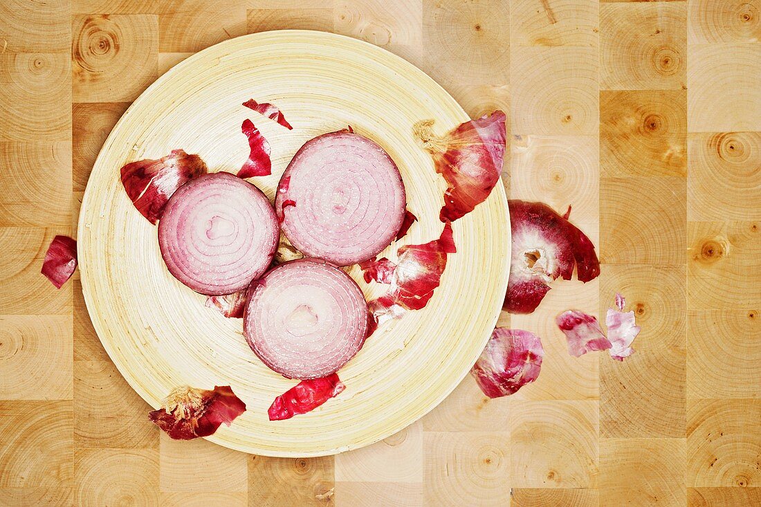 Slices of red onion and onion skin on plate
