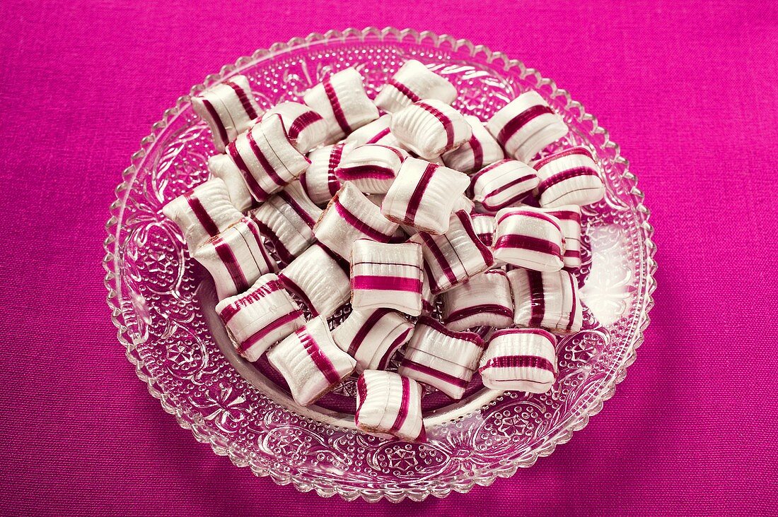 Cherry mint sweets on glass plate