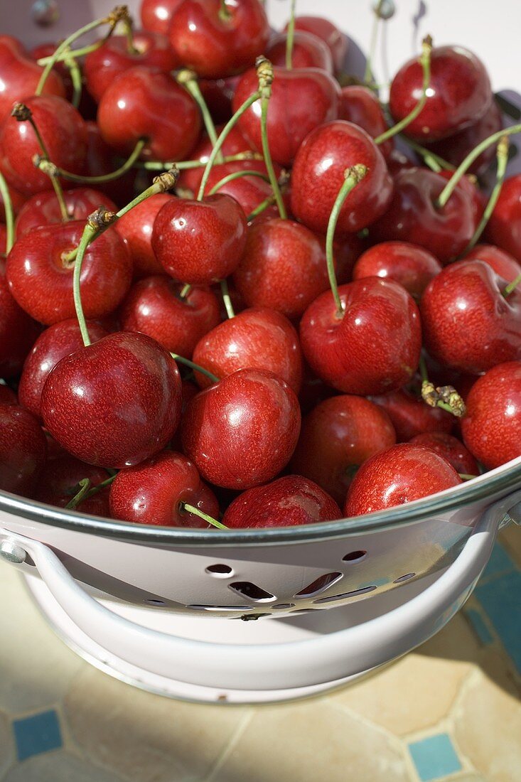 Fresh cherries in a colander
